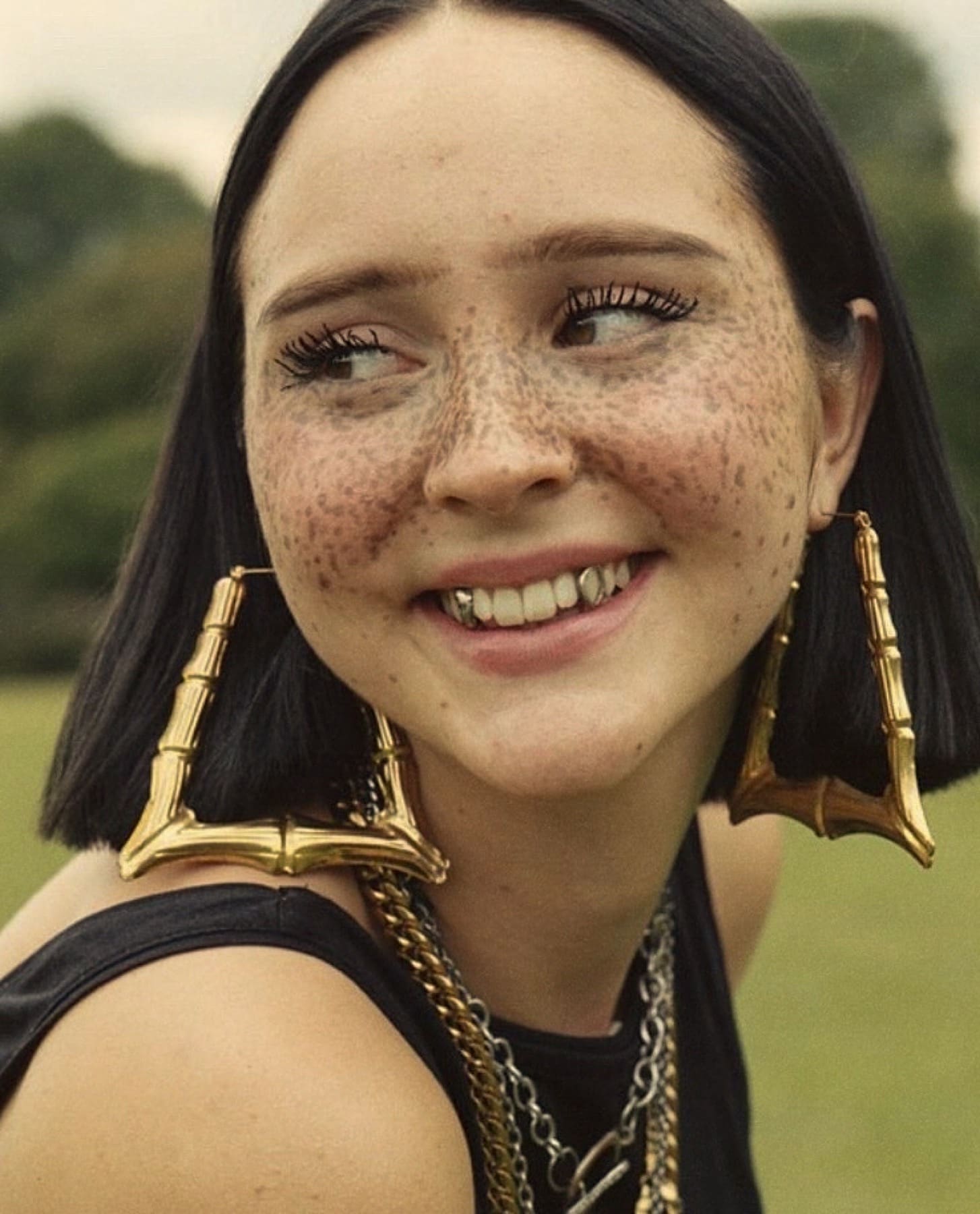 Portrait of a girl with teeth grills and short hair