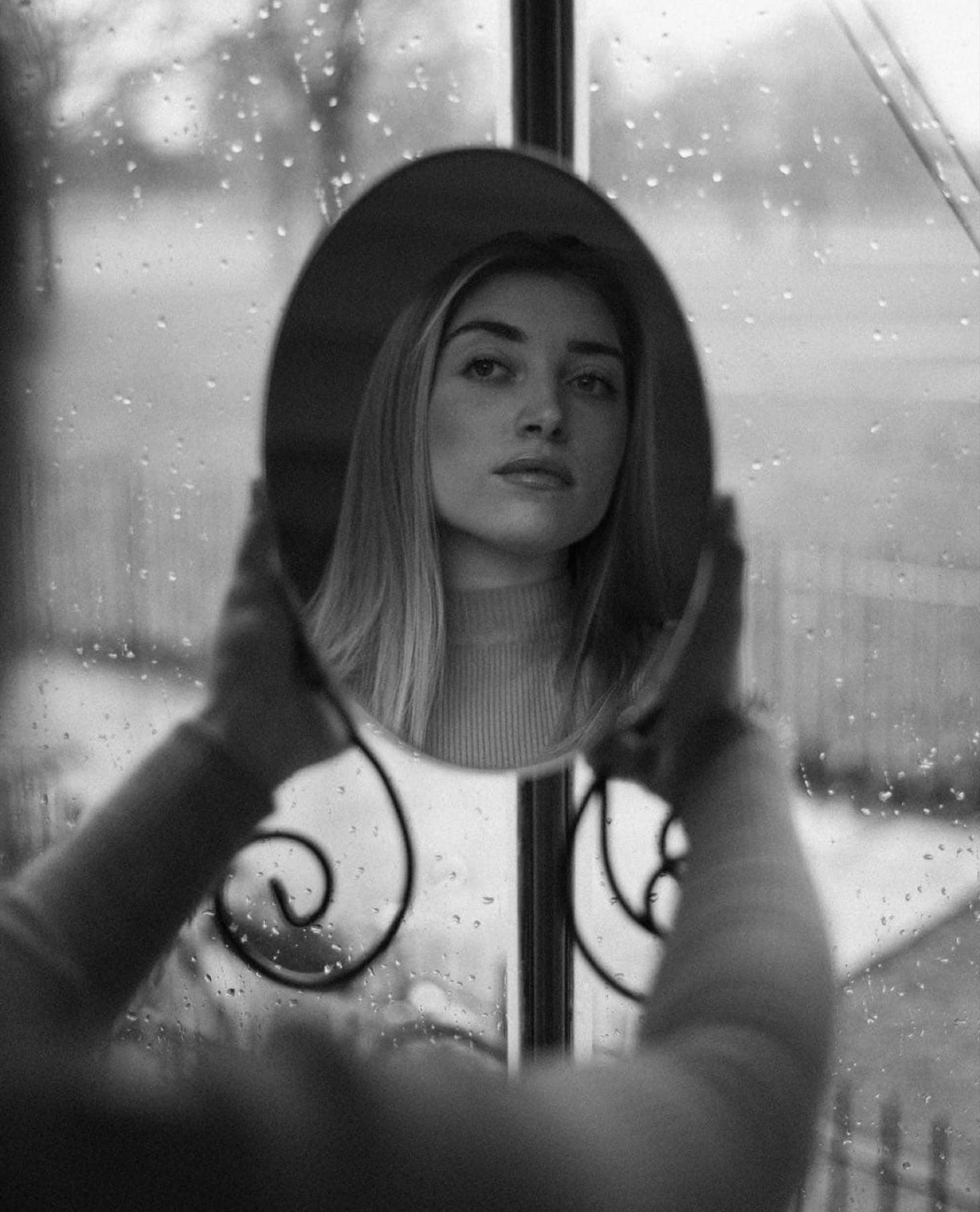 Portrait of a girl looking at her reflection in the mirror