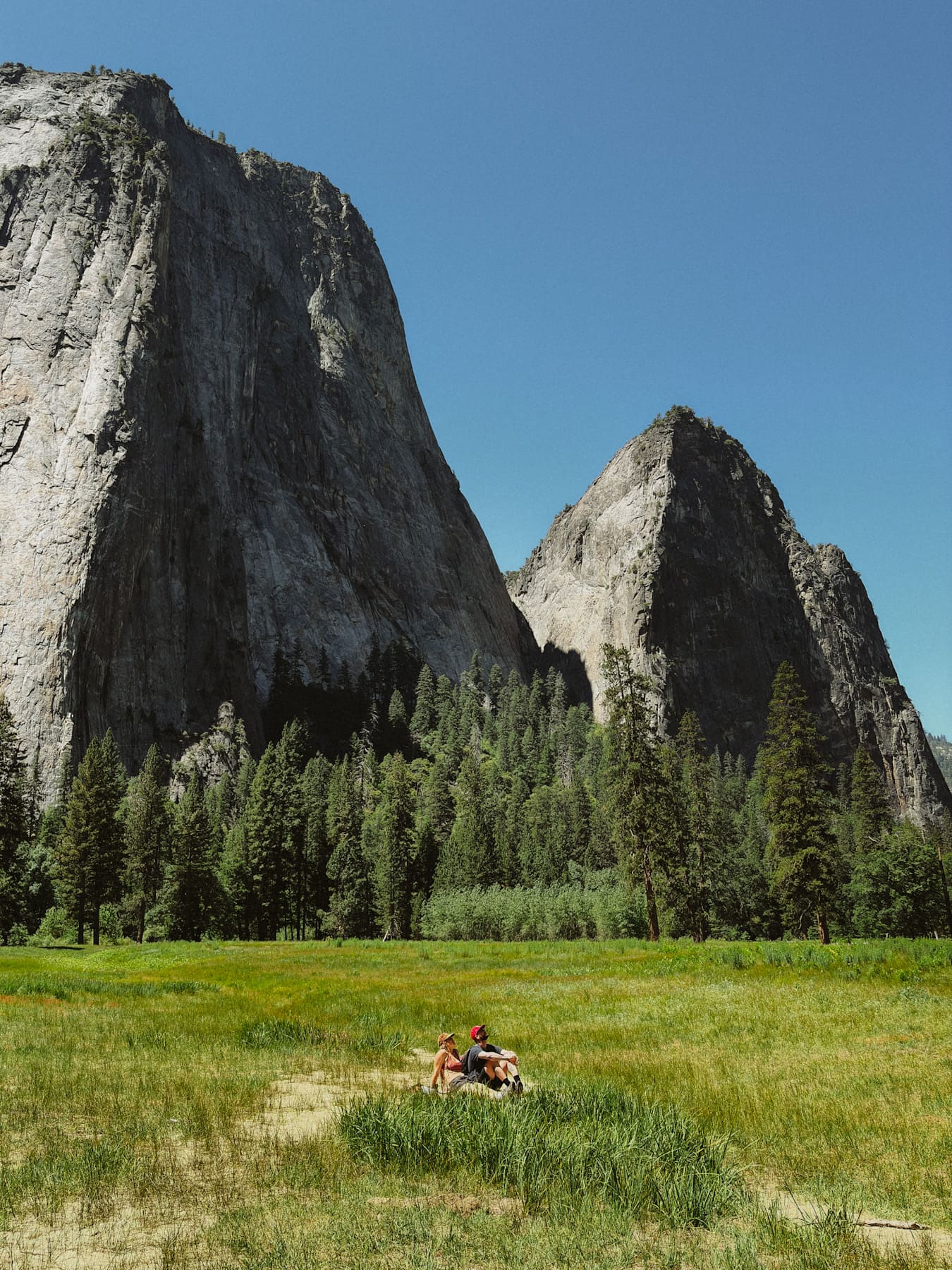 Two people looking out at El Capitan, Yosemite valley below