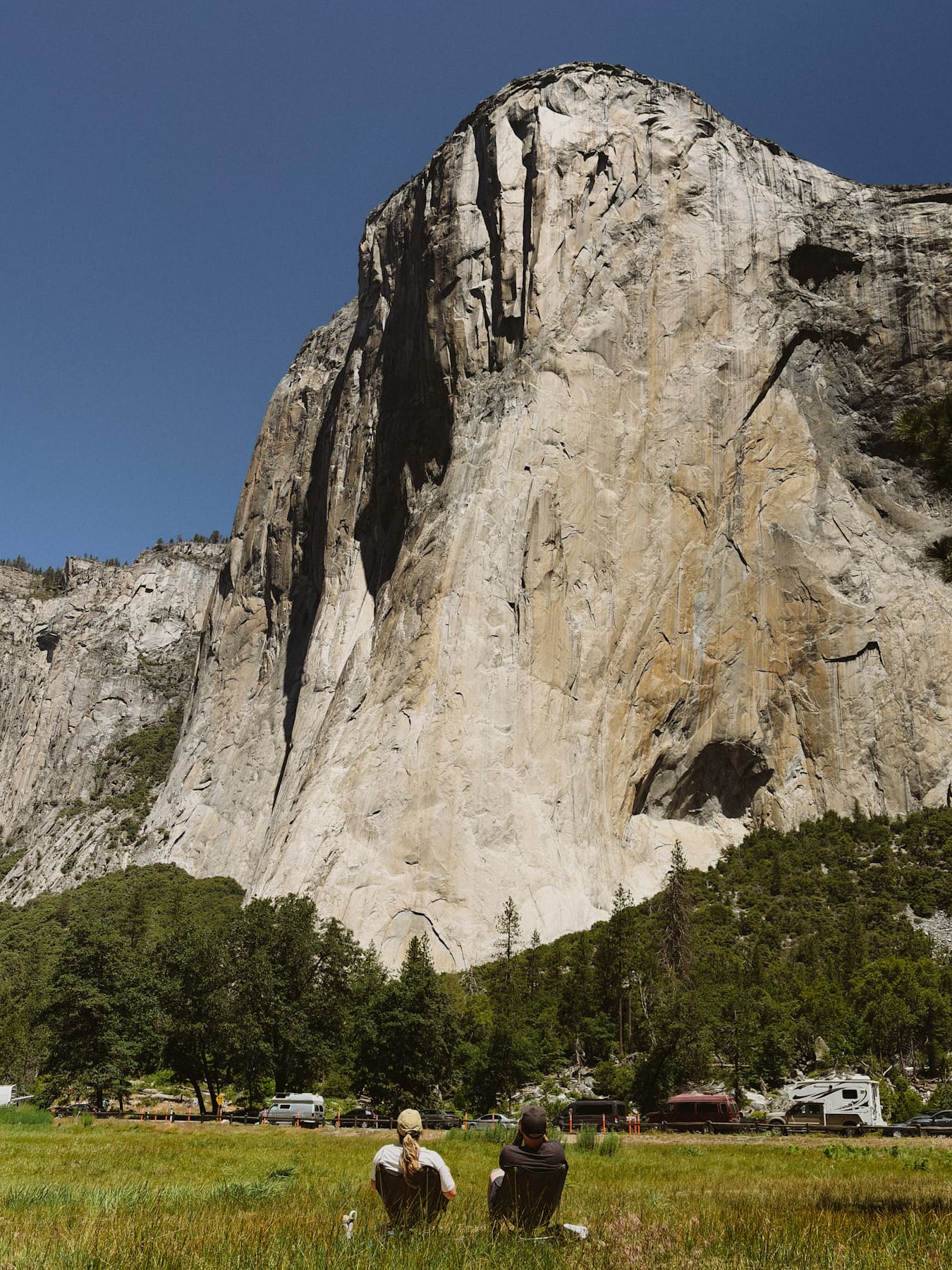 A couple sat looking at El Capitan in Yosemite