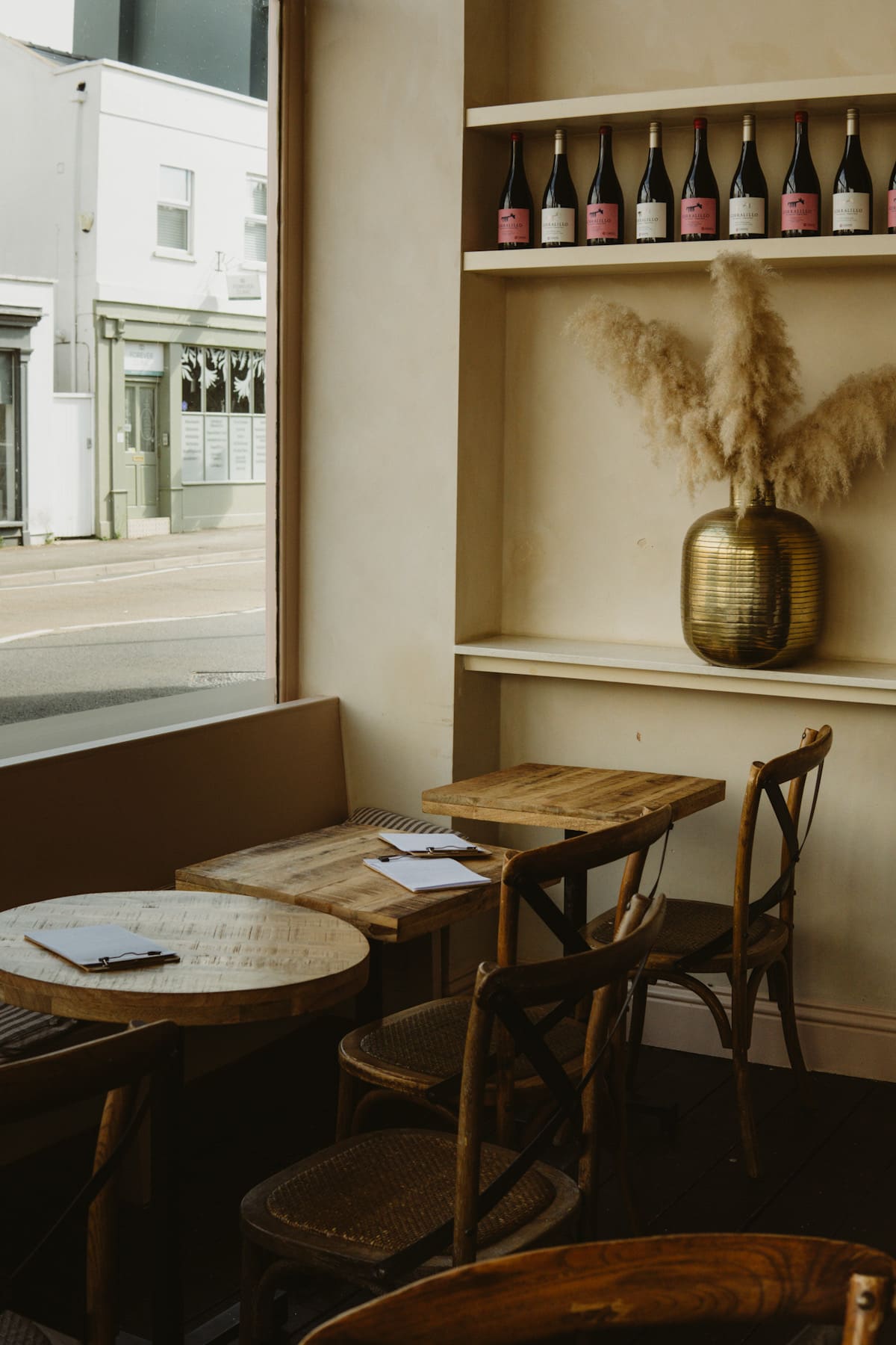 Nina cafe and wine bar showing a table and wine bottles on the wall